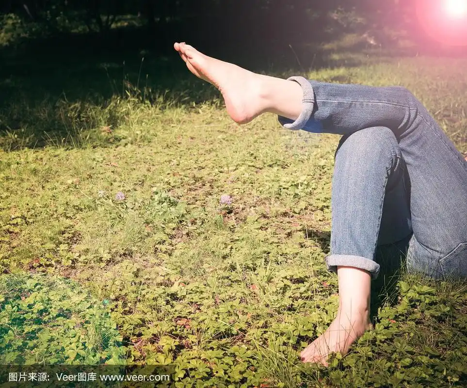 在夏日的阳光下,赤脚在草地上放松