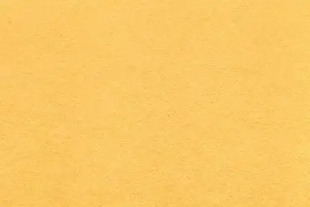 云豹的淡黄色旧的淡黄色的纸背景,特写的纹理.结构的致密柠檬纸板照片