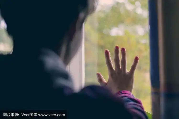 年轻悲伤的少年望着窗外