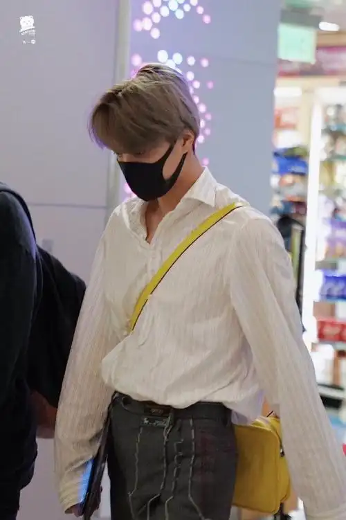 公开的机场照中,钟仁在工作人员的陪伴下进入候机室,身着oversize衬衣