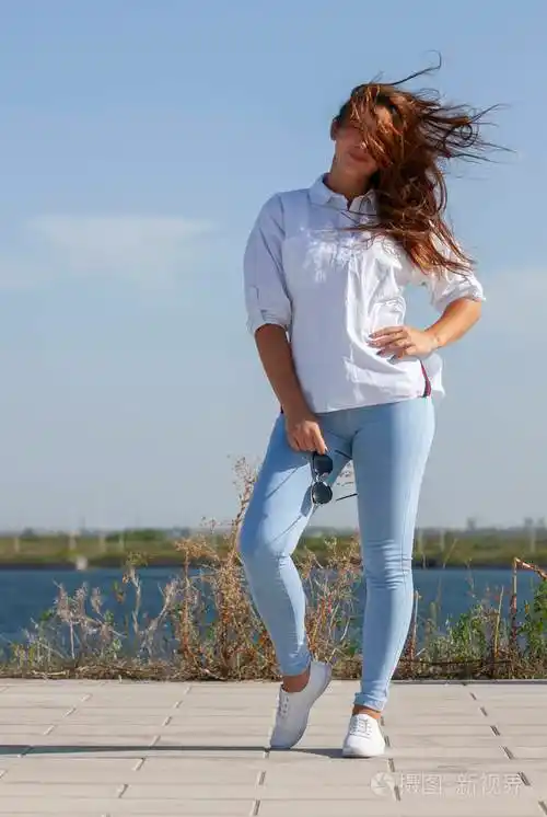 一位穿着蓝色牛仔裤的美女的全身肖像