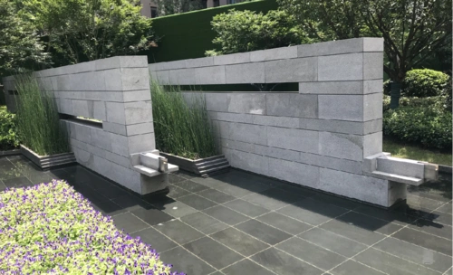 景墙巧妙地和水景结合,挑出的出水口呼应了整体的景观形式,也和古建筑