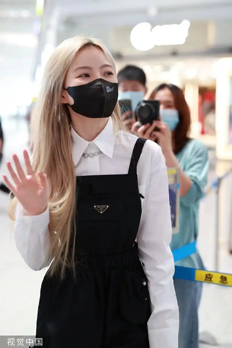 组图:陈卓璇白金发造型亮相北京机场 衬衫叠穿吊带裙元气十足