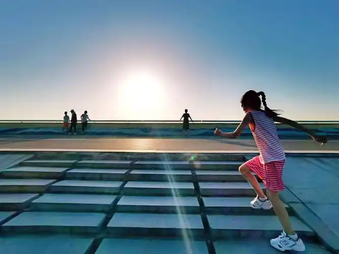 人们迎着初升的太阳晨跑,身姿骄健而优美.