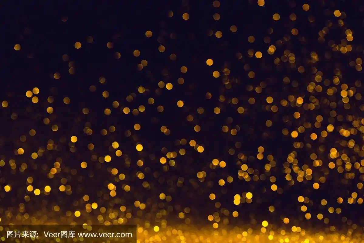 黑色背景上的金色闪光粉末