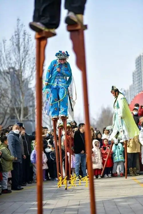2月10日,在济南阳光新路一商场门前,一场高跷表演烘托出浓浓的节日