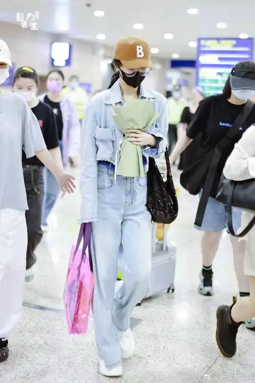 杨紫结束海外行程回国, 穿着一身短款牛仔套装造型, 搭配棕色棒球帽