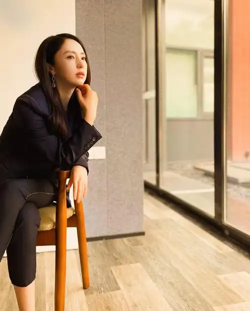 董璇着深色西装长发柔逸温婉知性 暖色渲染明媚美貌萦绕温柔气息