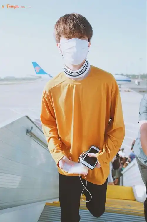 范丞丞戴口罩穿橙色卫衣搭配黑色休闲裤现身机场难道脖子不热吗