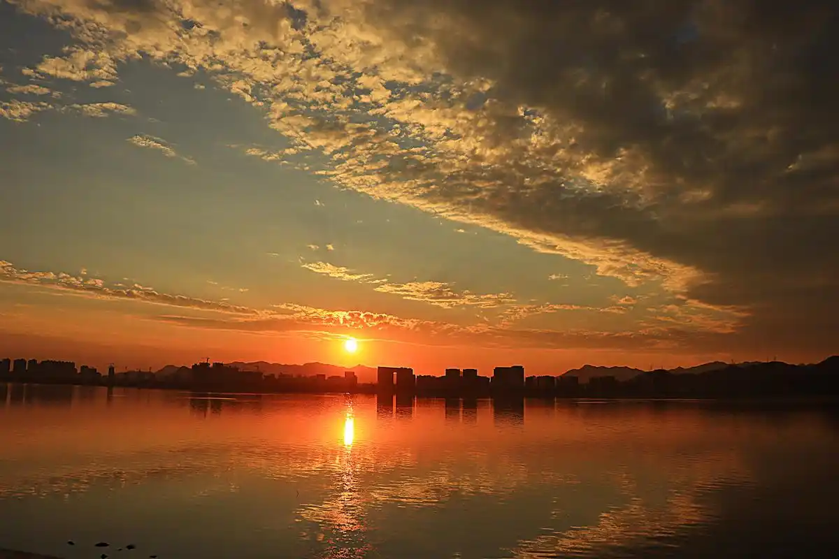今天傍晚在柔和的阳光和漂亮的云彩下,湖面荡起涟漪,波光粼粼,倒影着