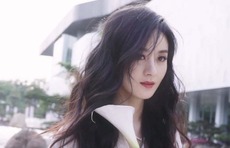 赵丽颖拍绝美大片,大波浪长发飘飘凹造型侧颜优越,低眉浅笑姿态优雅