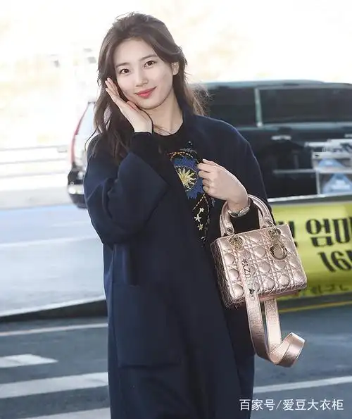 秀智穿深蓝色大衣显高挑身材,玫瑰金包包打破整身的沉闷色调