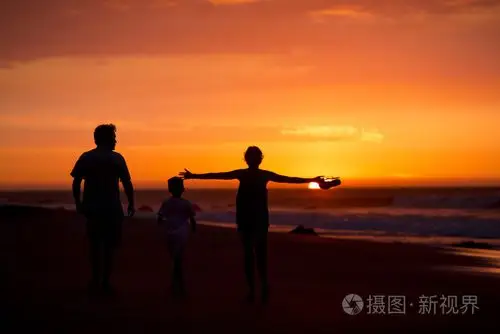 秘鲁黄昏海滩上的家庭剪影
