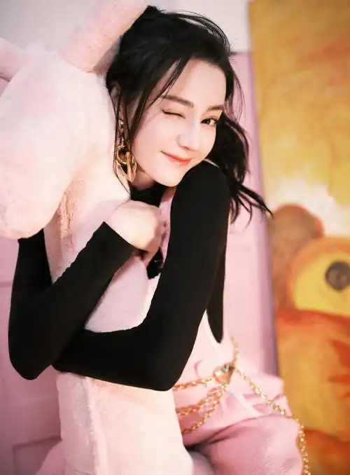 迪丽热巴穿黑色打底衫搭配粉色背带裤,整体造型看起来简约温暖,清新