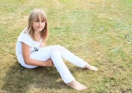 脚草地草地上的赤脚女孩照片