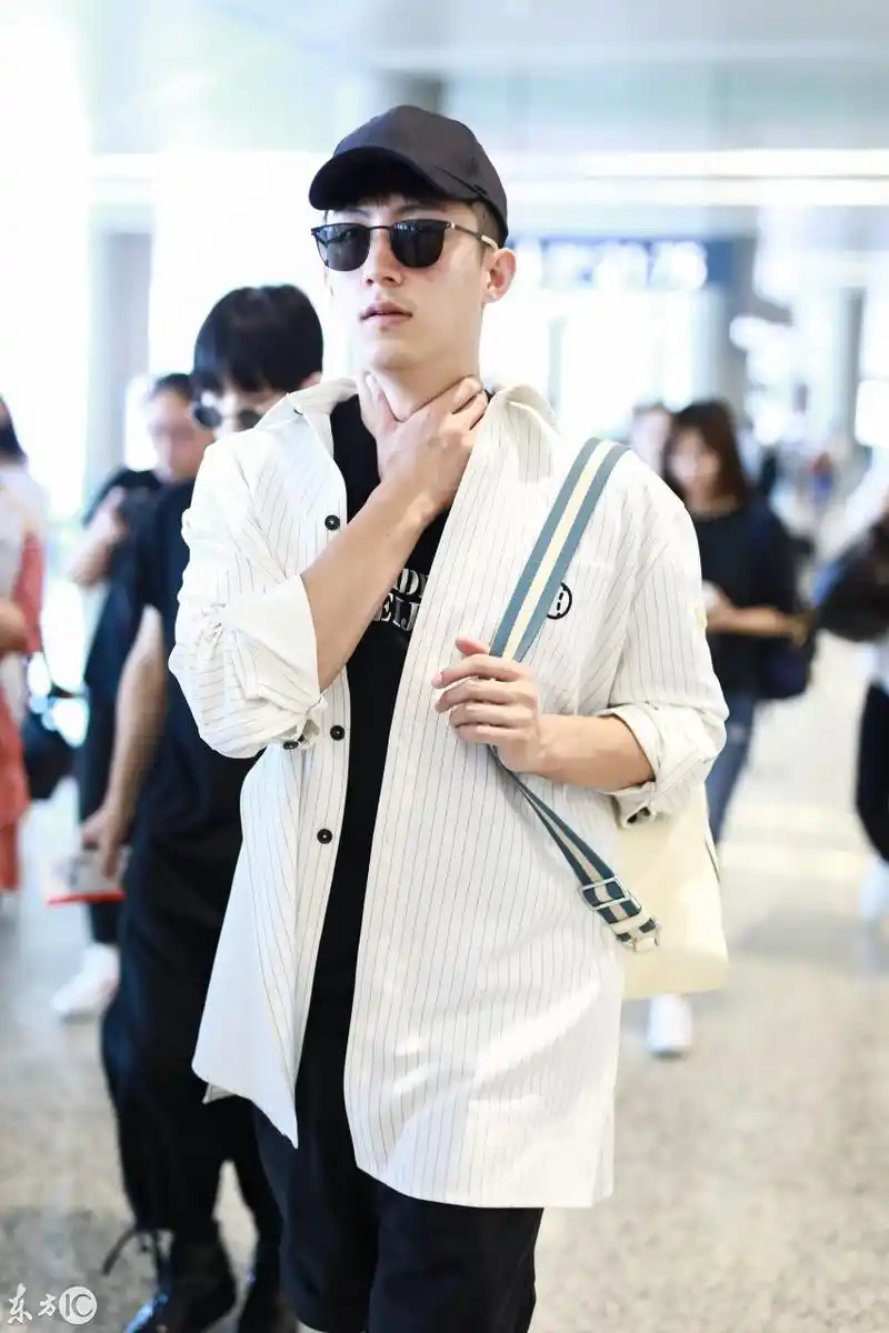 黄景瑜穿白条纹衬衫搭配黑短裤现身机场,戴棒球帽和墨镜又酷又帅
