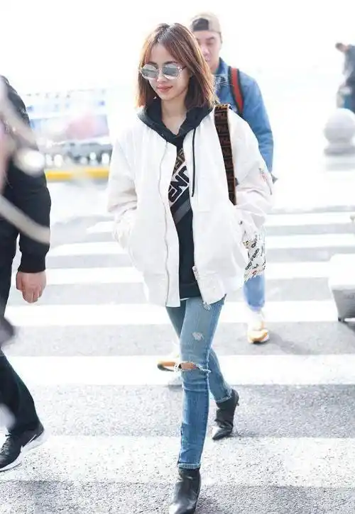 蔡依林机场素颜照,白色外套搭配破洞牛仔裤,歪头甜笑少女感十足_照片