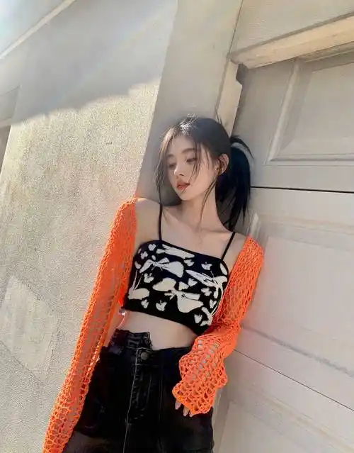 鞠婧祎穿着黑白蝴蝶毛巾绣吊带打底,下搭黑色高腰牛仔裤,甜辣性感又