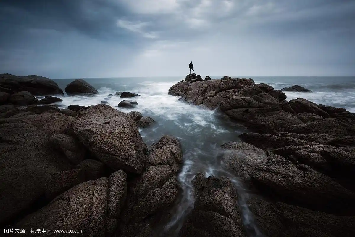 站在海边礁石上的一个人