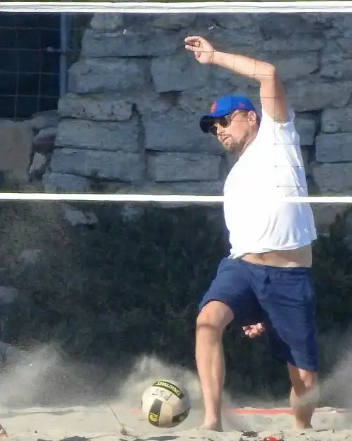 "小李子"与朋友打沙滩排球姿势太销魂 大肚腩突出发福严重