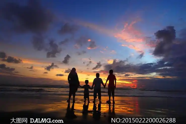 海边一家四口看黄昏美景摄影图片