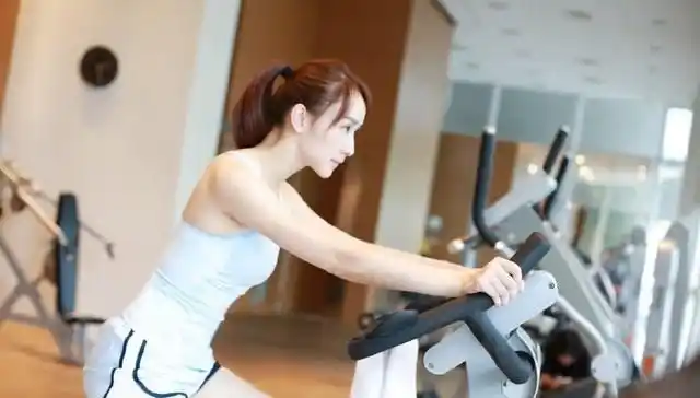 胡静做着各种健身动作,皮肤白皙,身材姣好