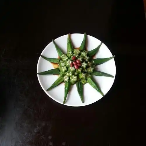 放开水锅中淖水一分钟,捞出放入冰水中降温秋葵切去蒂,切小块摆盘,浇