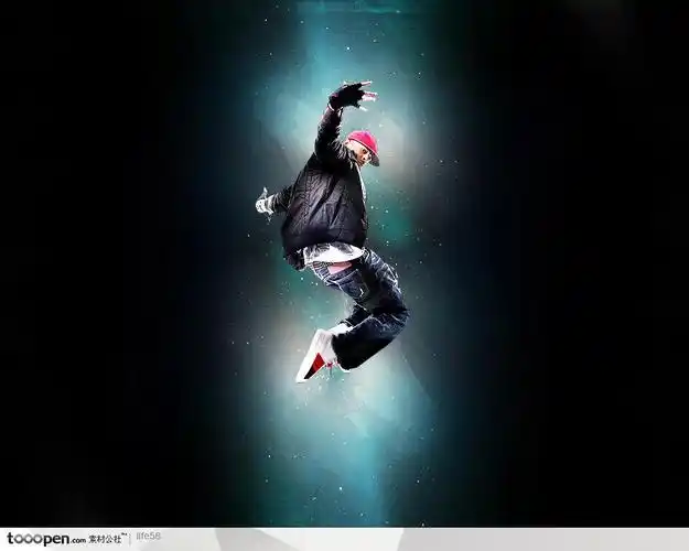 黑暗光芒照射下的带红色帽子的运动男孩跳街舞精品分层素材