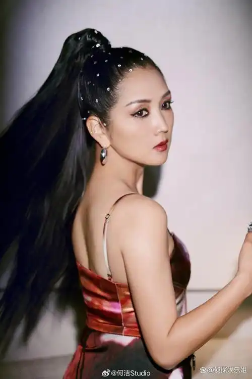 照片中,何洁扎着利落的高马尾,化着惹火的烈焰红唇美妆,身穿红色吊带
