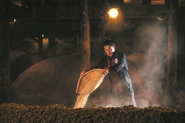 在古作坊内,酿酒师采用古法酿酒.