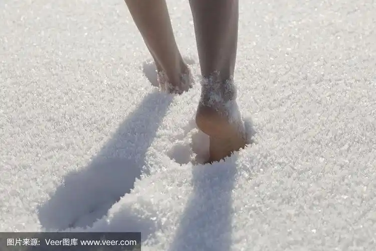 赤脚在雪地里行走的女性