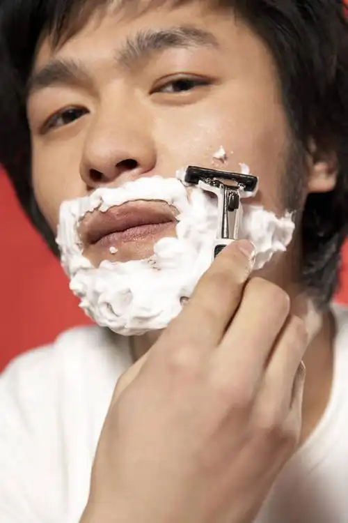 年轻男子刮胡子