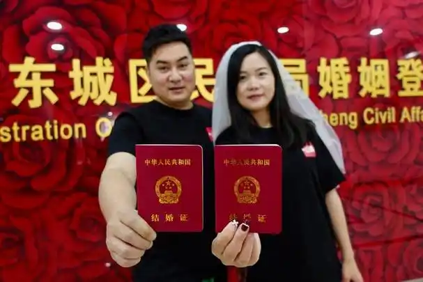 一对新人展示他们的结婚证.新京报记者 郑新洽 摄