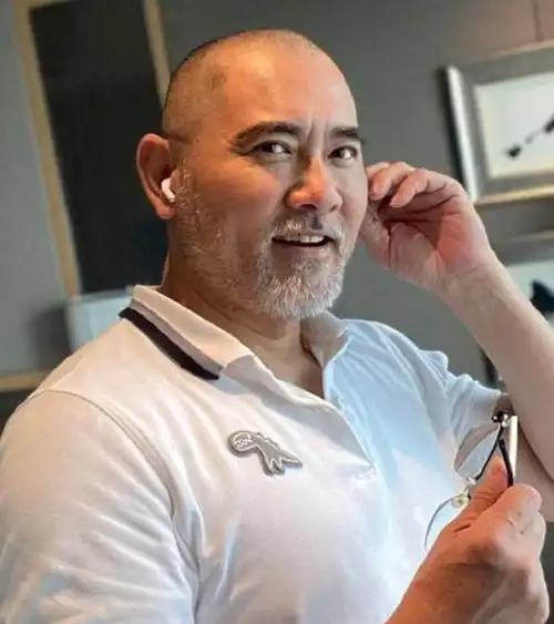 照片中他留着一脸把花花的络腮胡,一幅光头形象,看起来与之前年轻时候