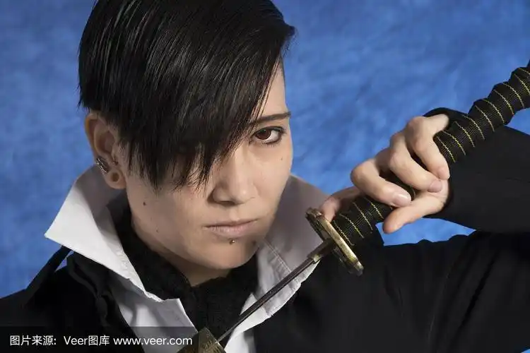 正面的年轻亚洲男子画武士刀,特写.