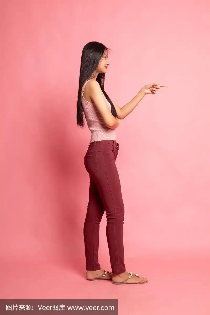 全身侧视图美丽的年轻亚洲女人指向.