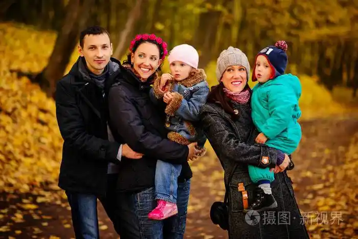 走在秋天的公园有两个孩子的家庭