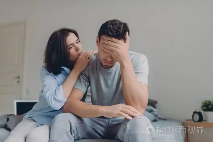 有吸引力的女性安慰她悲伤的男朋友,谁有抑郁和一些问题在卧室的床上