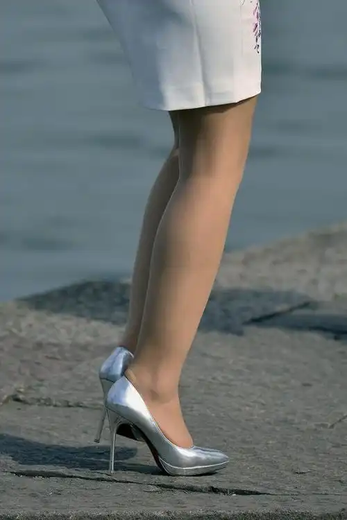 绣花白色裙的古典美和银色细跟高跟鞋的现代美很好结合的美腿女孩