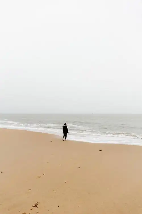 沙滩上漫步的女人图片