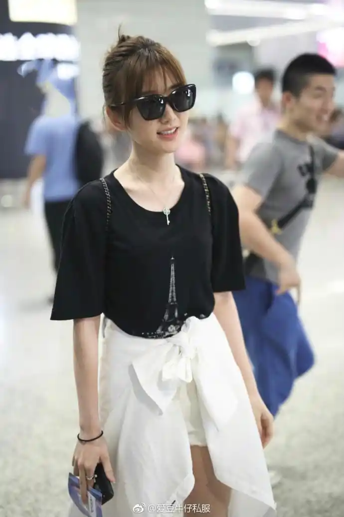 毛晓彤戴墨镜穿黑t恤搭配白短裤现身机场,把衣服绑在腰上很时髦
