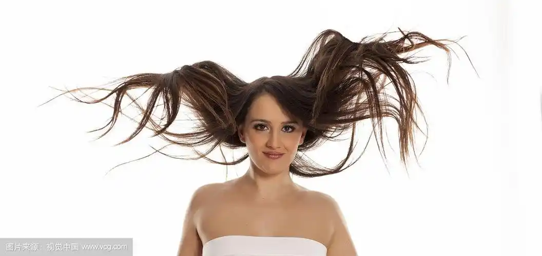 年轻快乐的女人,飘逸的头发在白色的背景