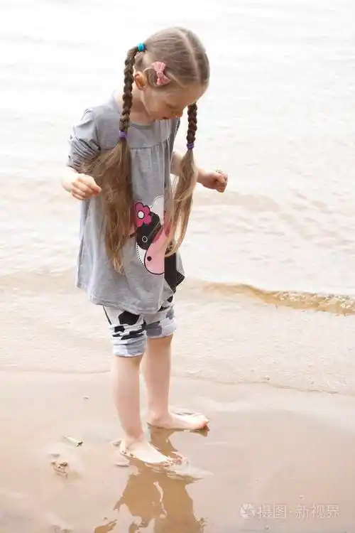 光着脚的小女孩站在河边