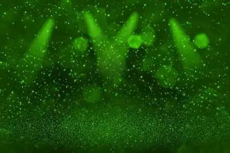 绿色,奇妙,闪闪发光的抽象背景舞台聚光灯与火花飞离焦bokeh假日模型