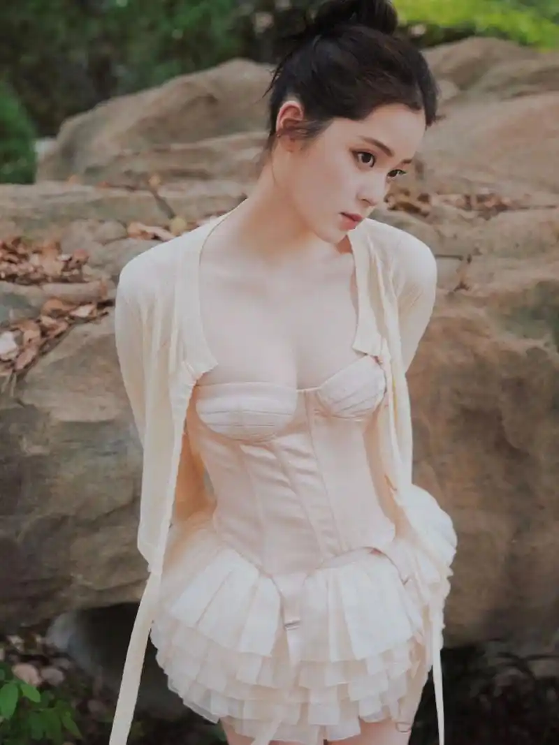 欧阳娜娜户外拍写真穿搭,穿白色抹胸蛋糕短裙外搭米色针织开衫,甜美与