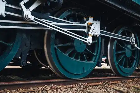 旧的老式火车车轮与青金属说停在锈迹斑斑的铁轨上照片