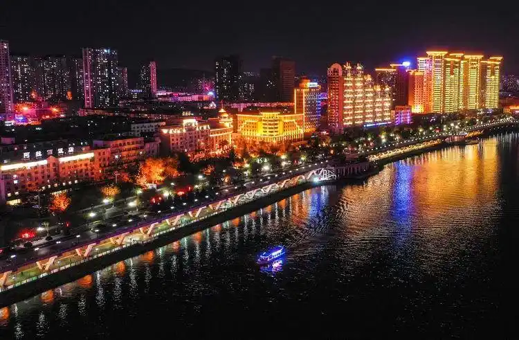 这是5月11日无人机拍摄的松花江吉林市段夜景,一艘游船行驶在江面上.