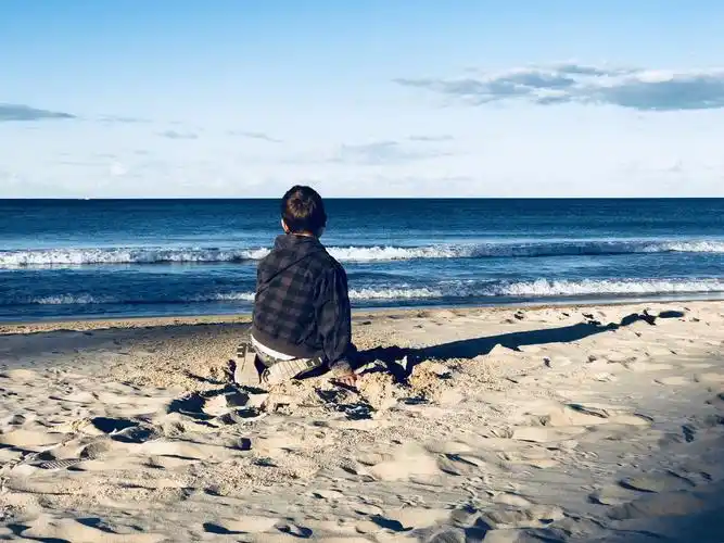 2018年悉尼冬季,热闹的海滩角落独自看海的男孩