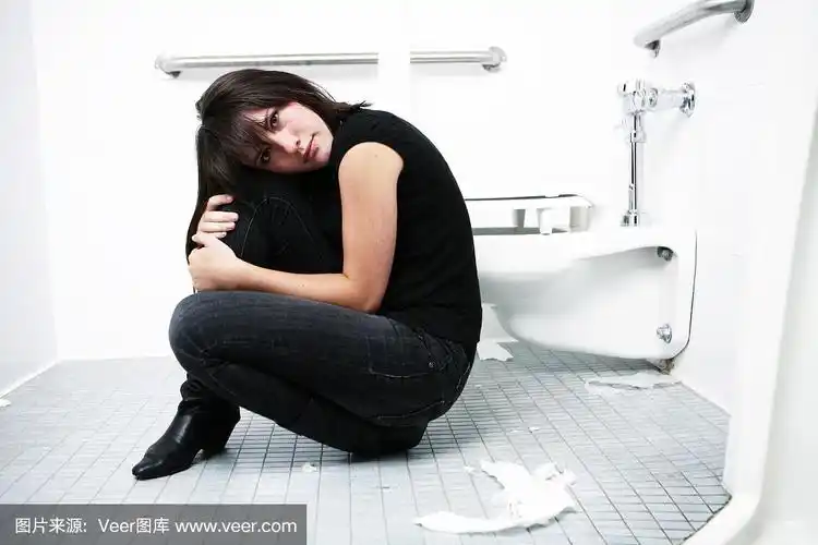 女孩蜷缩在公共厕所的地板上