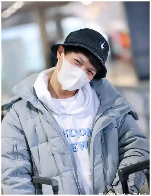 周深现身机场,卫衣搭配羽绒服,歪头一笑太可爱!_白色_造型_风格